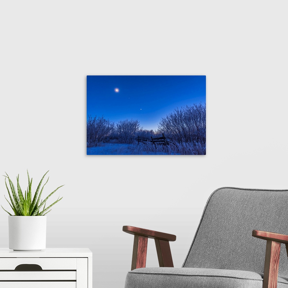 A modern room featuring Venus, Mars and the moon over a frosty fence.