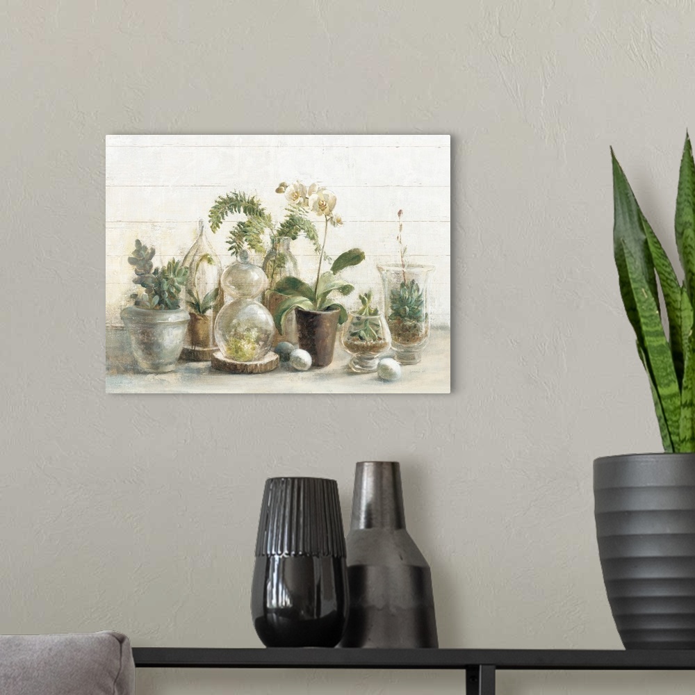 A modern room featuring A contemporary painting of a group of glass covered succulents and orchids against a white wood w...