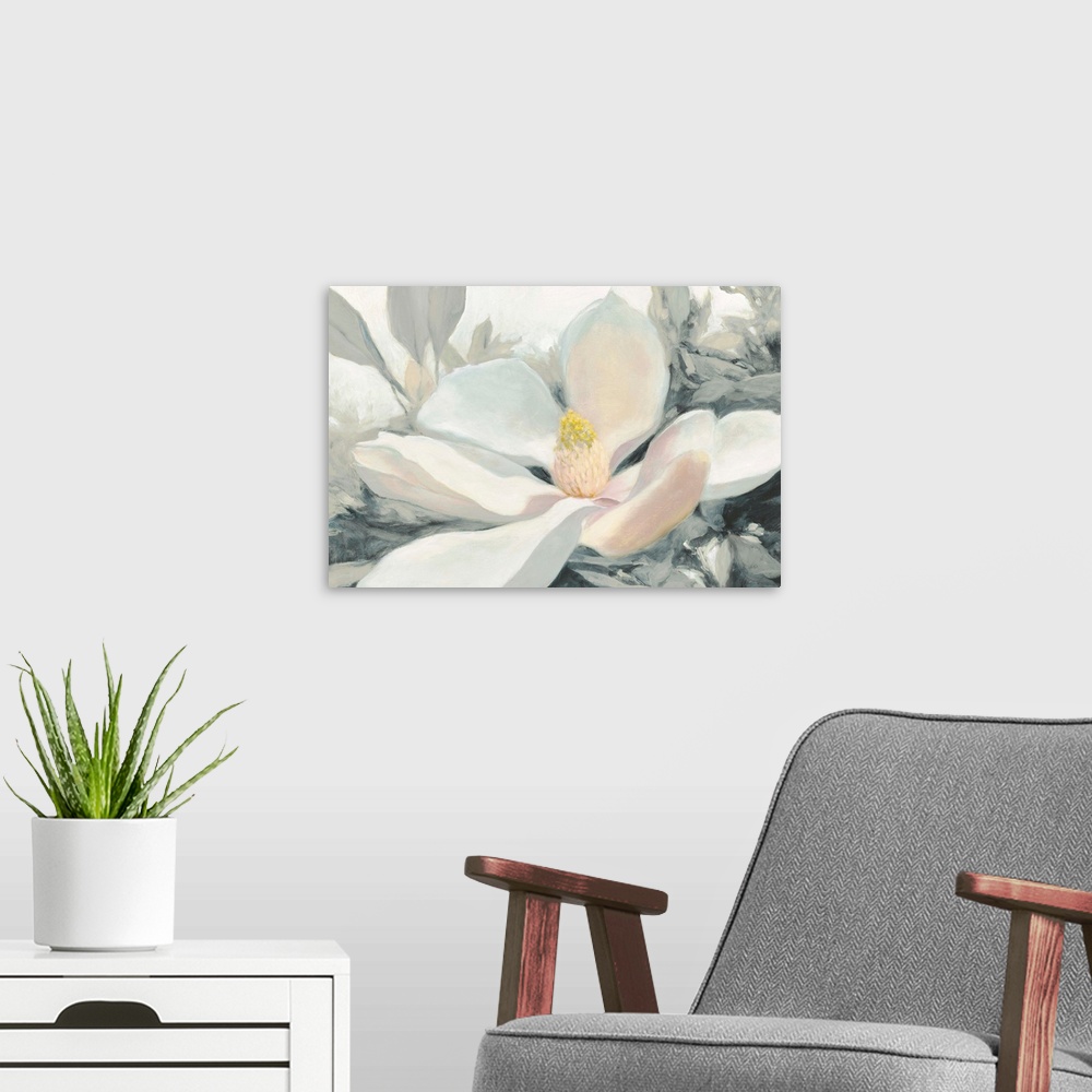 A modern room featuring A large close up painting of a magnolia bloom in shades of yellow, pink and gray.