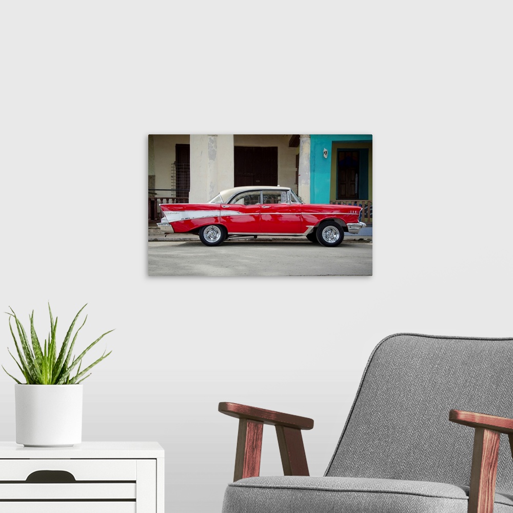 A modern room featuring A photograph of a colorful vintage car in Cuba.