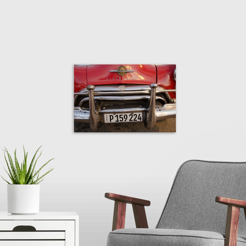 A modern room featuring A photograph of a colorful vintage car in Cuba.