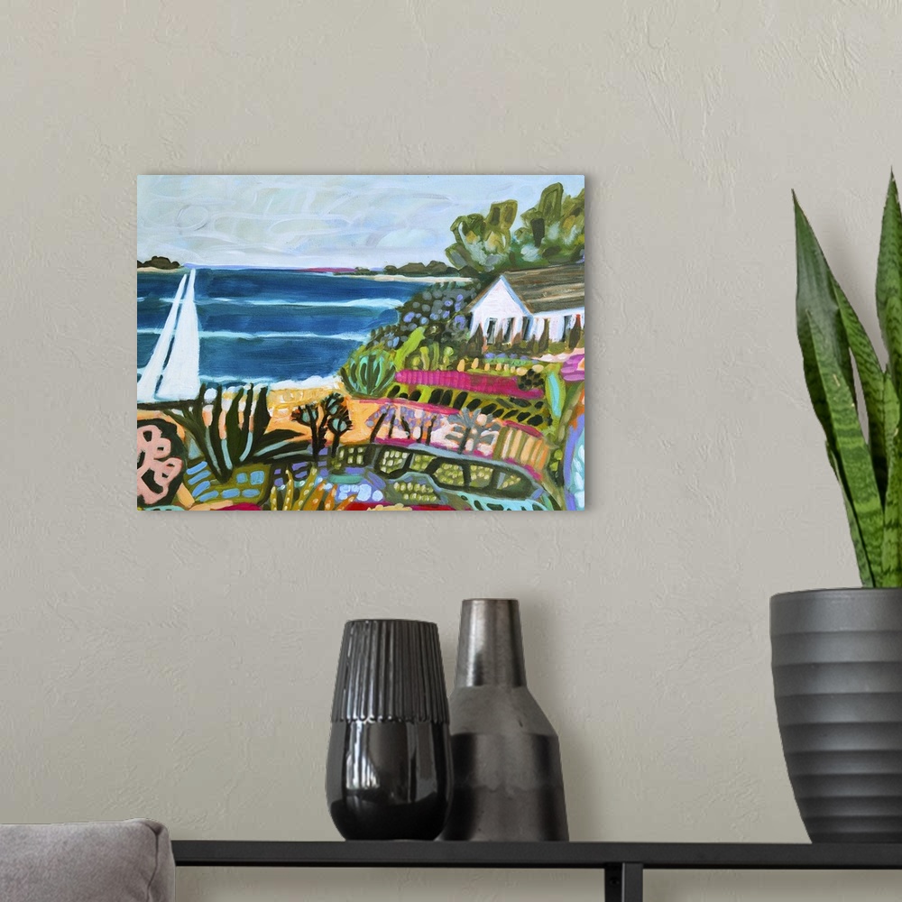 A modern room featuring Colorful artwork of a house on the beach with a sailboat on the water.