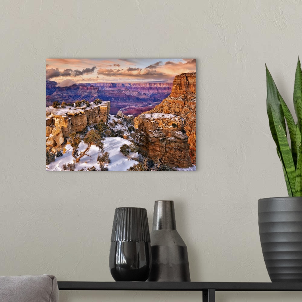 A modern room featuring Vista of the Grand Canyon in Arizona on a cloudy day under a blanket of snow.