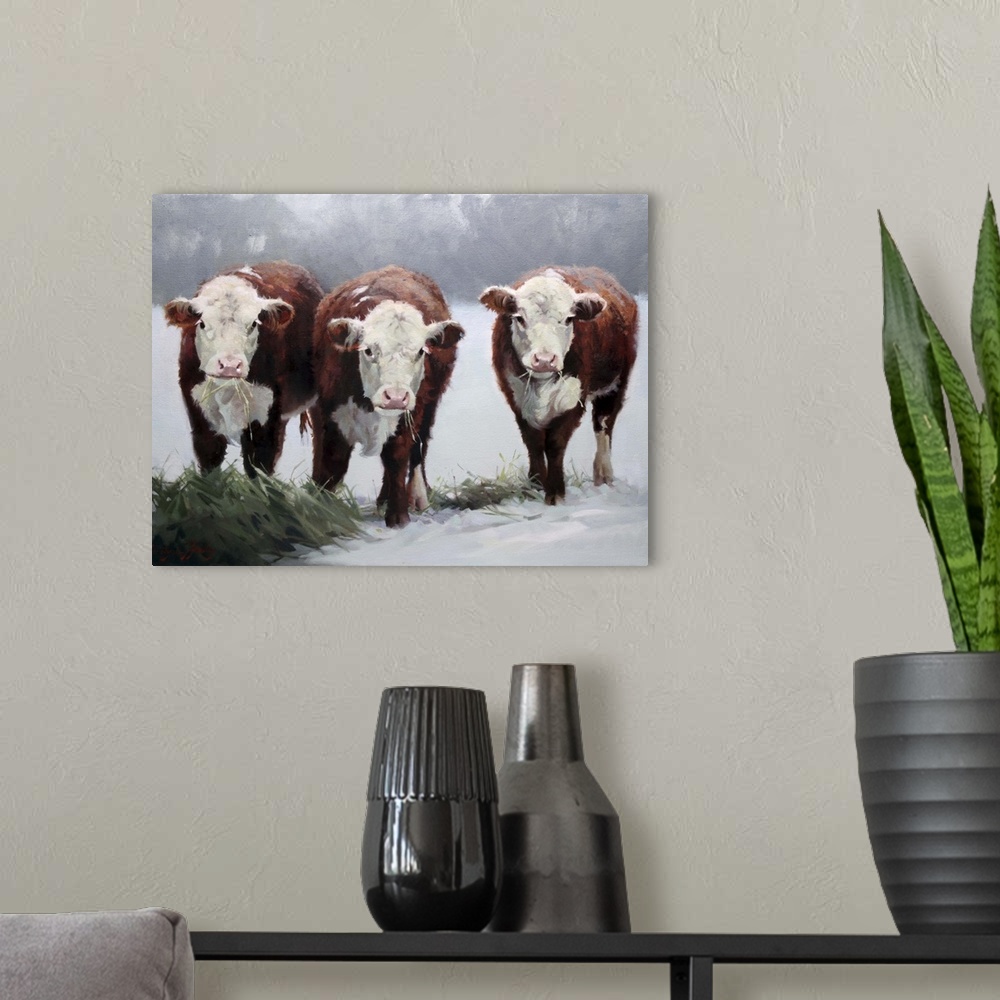 A modern room featuring Contemporary artwork of three brown and white cows in the snow.