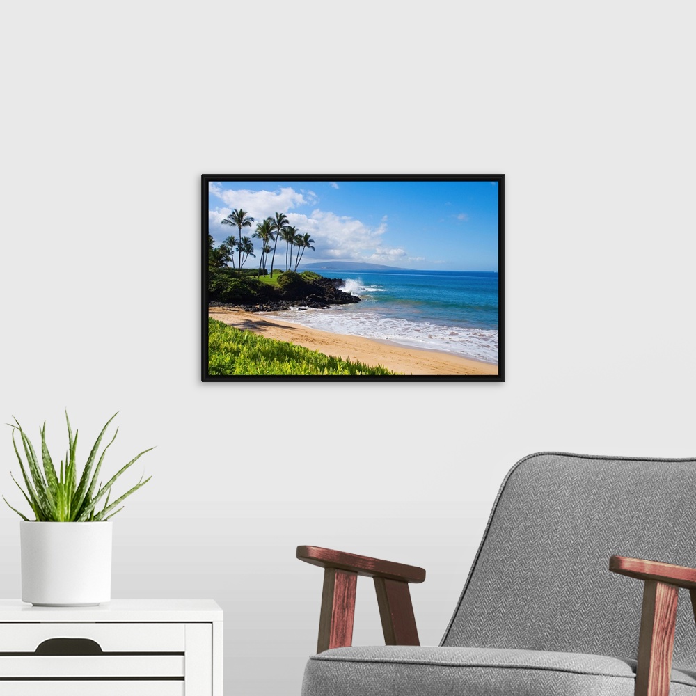 A modern room featuring An idyllic photograph of the Hawaiian coast, with gently lapping water under a bright blue sky. T...