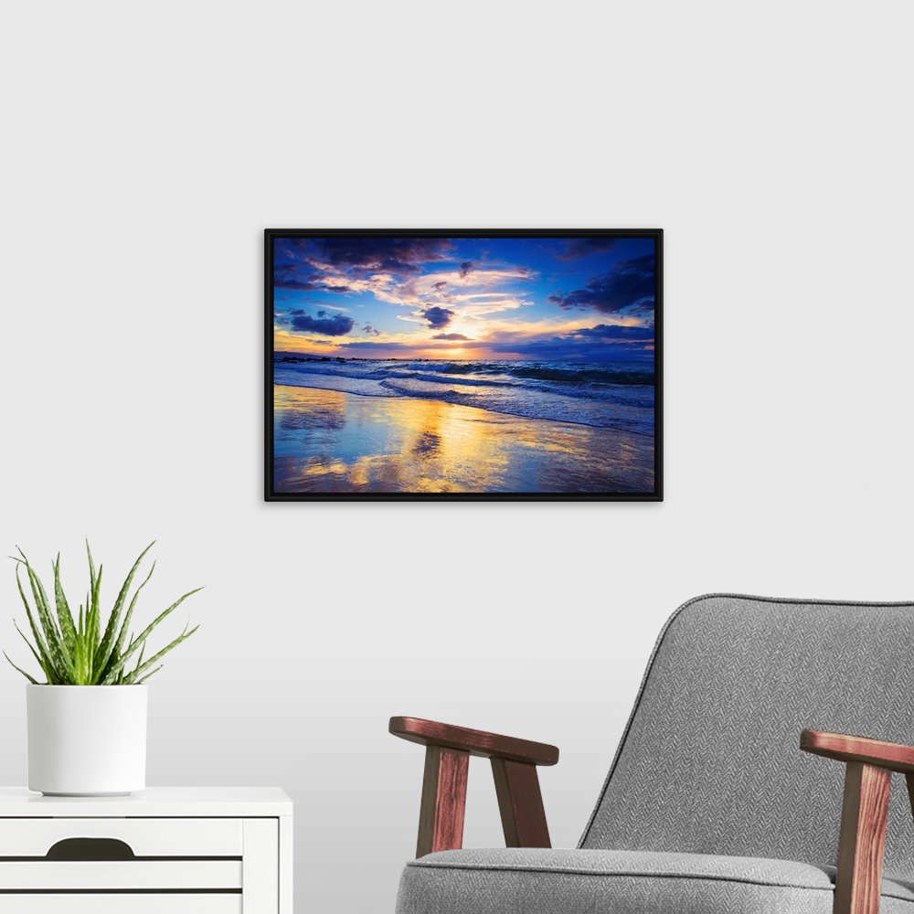 A modern room featuring Horizontal photograph on a large wall hanging of a vivid sunset glowing through clouds, over the ...