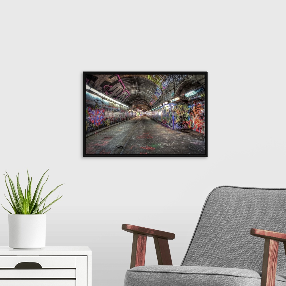 A modern room featuring HDR photograph of city tunnel walls covered in graffiti.