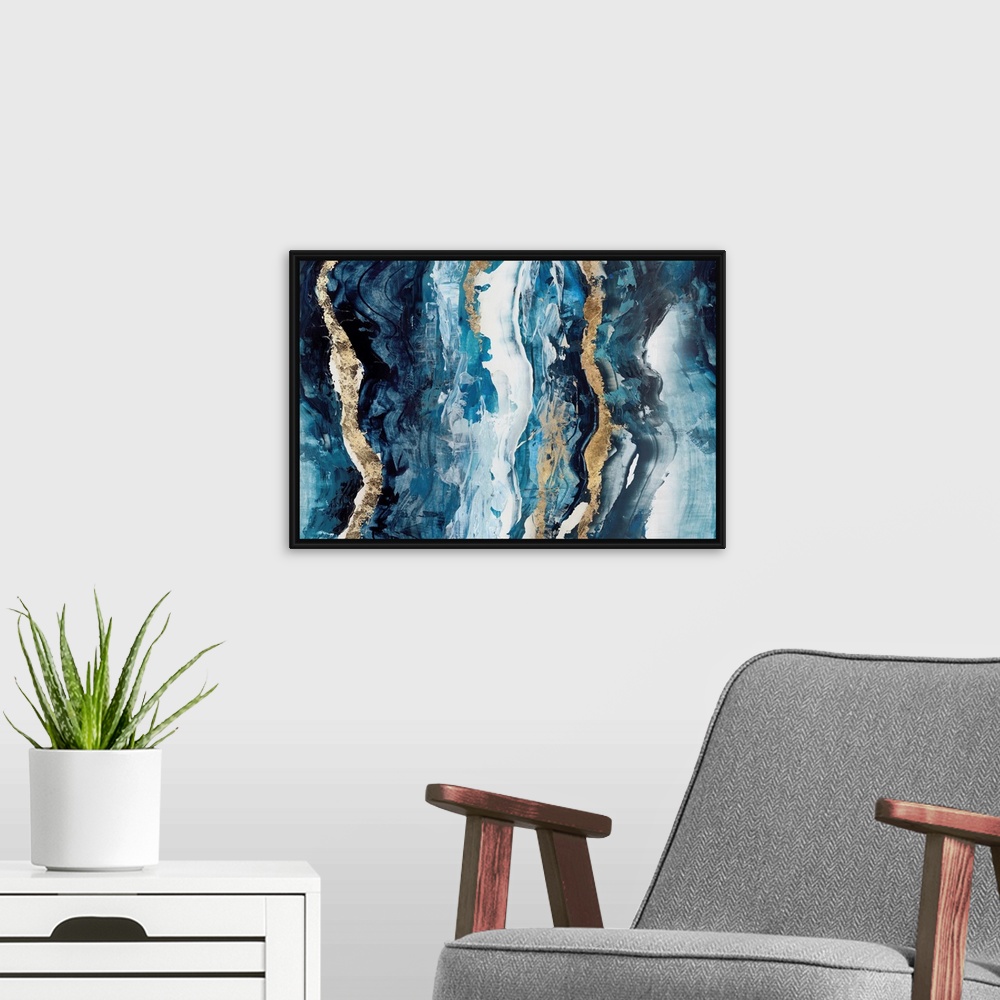A modern room featuring A horizontal abstract of vertical wavy brush strokes in blue with gold accents.