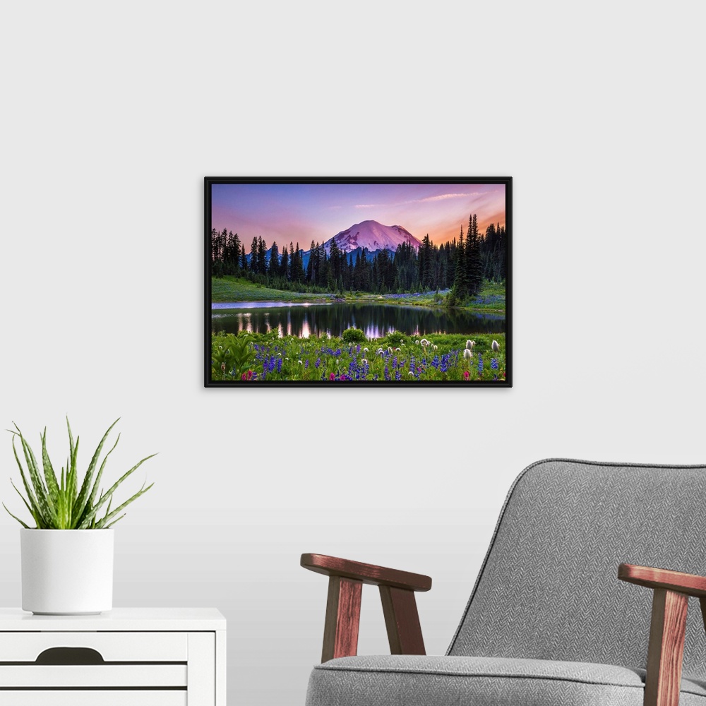 A modern room featuring Flowers along the edge of a lake with Mount Rainier in the distance, at sunset.