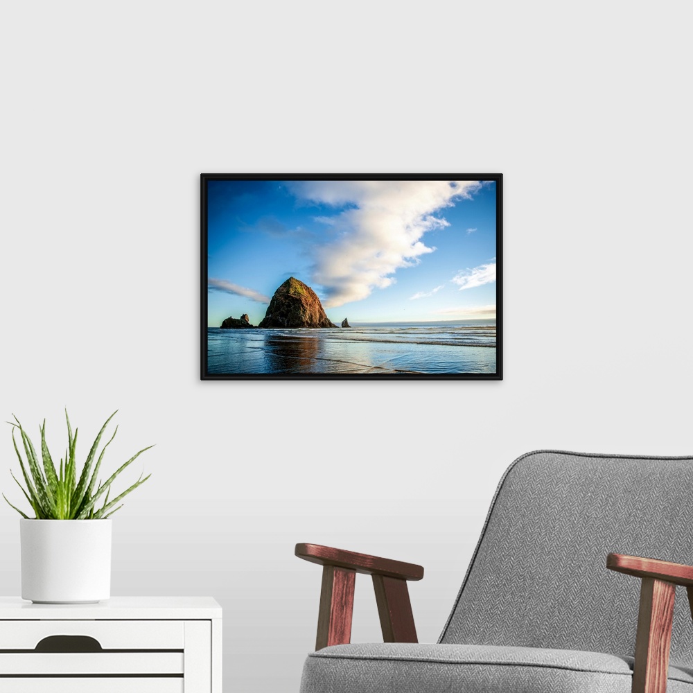 A modern room featuring Panoramic photograph of Haystack Rock at golden hour, just before sunset, Cannon Beach, Oregon.