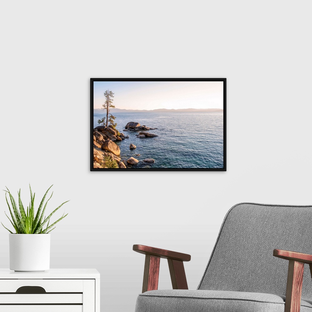 A modern room featuring View of Lake Tahoe's rocky shore with mountain landscape in the background in California and Nevada.
