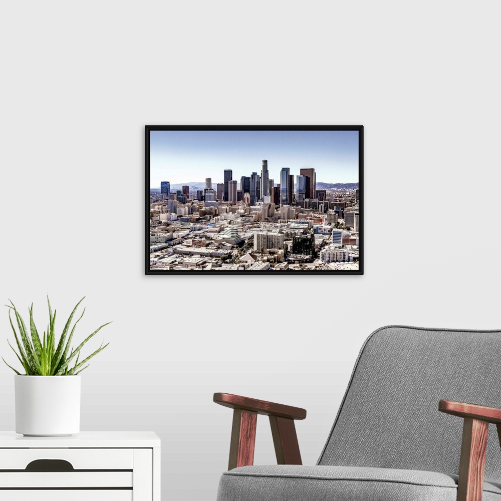 A modern room featuring Skyscrapers and surrounding buildings of the Los Angeles skyline under a blue sky, California.