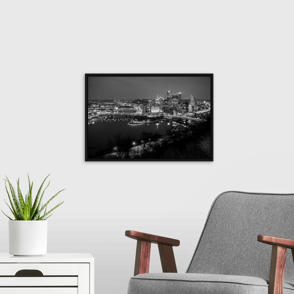 A modern room featuring Photo of downtown Pittsburgh at night with Point State park.
