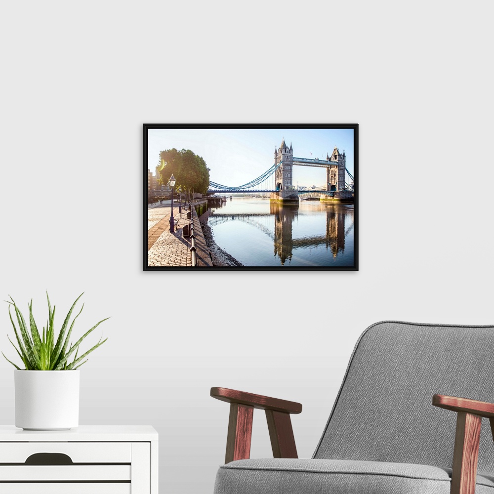 A modern room featuring Photograph of Tower Bridge  reflecting on River Thames with a brick sidewalk on the side.