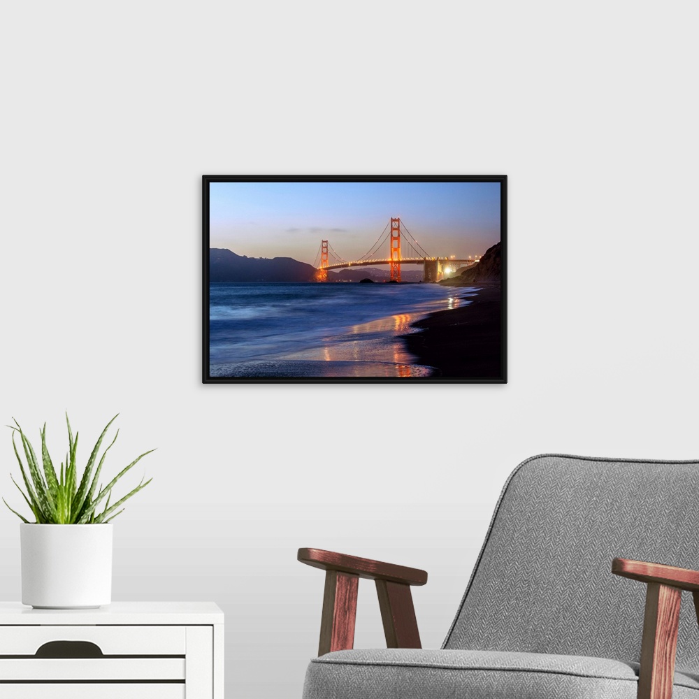 A modern room featuring Twilight photograph of the Golden Gate Bridge taken from the shore.