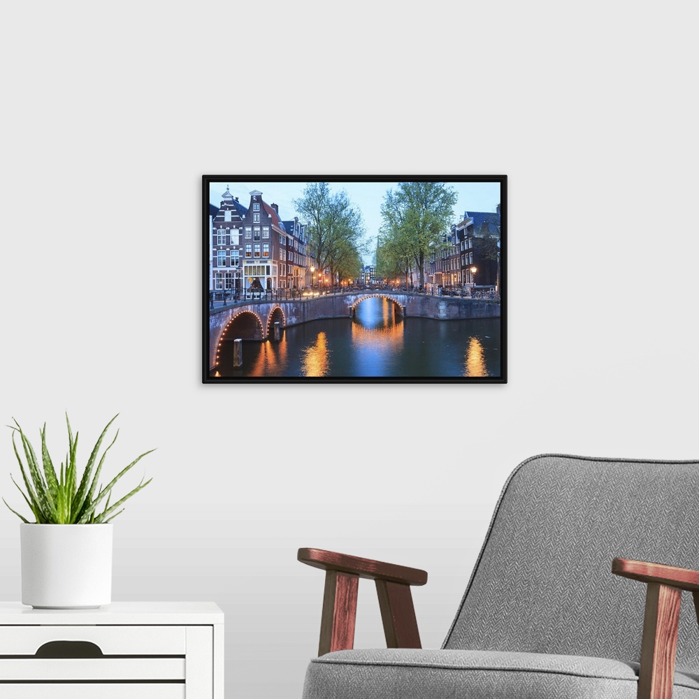 A modern room featuring Keizersgracht and Leidsegracht canals at dusk, Amsterdam, Netherlands, Europe.