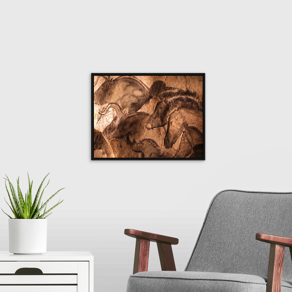 A modern room featuring Stone-age cave paintings. Artwork depicting various animals painted on the wall of a cave. These ...
