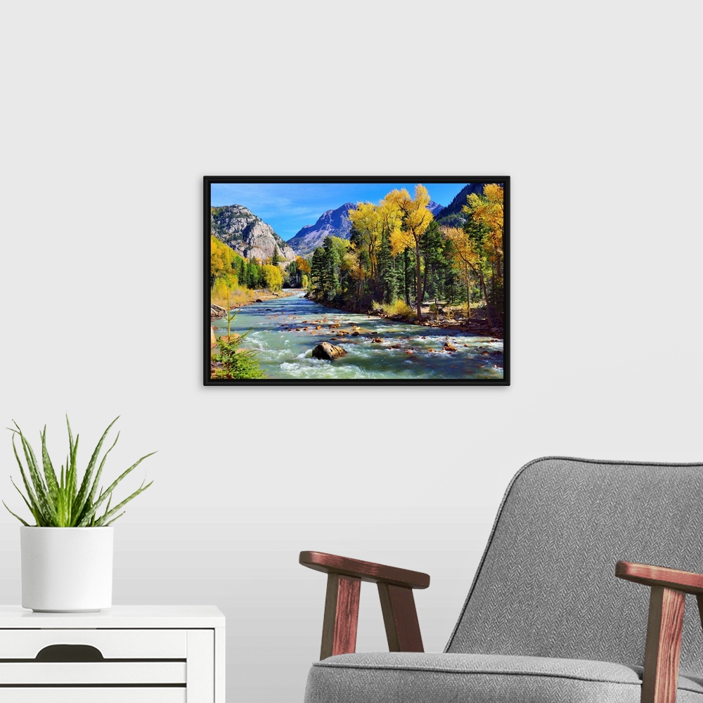 A modern room featuring mountain river and colorful mountains of Colorado.