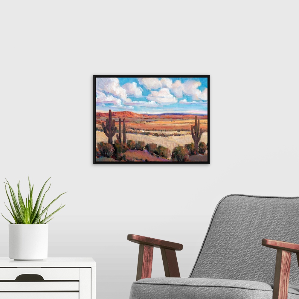 A modern room featuring Contemporary landscape painting of a bright blue cloudy sky overlooking a desert.