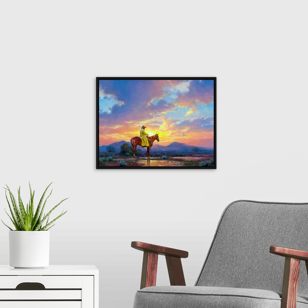 A modern room featuring Painting of man in trench coat on horse in desert at sunset.  There are mountains in the distance.