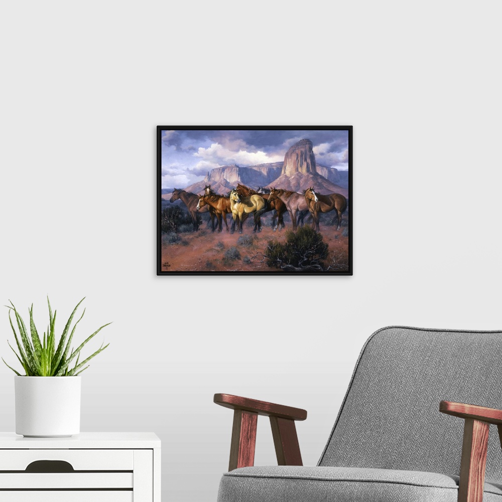 A modern room featuring Contemporary Western artwork of a herd of wild horses in a canyon standing alert and still.