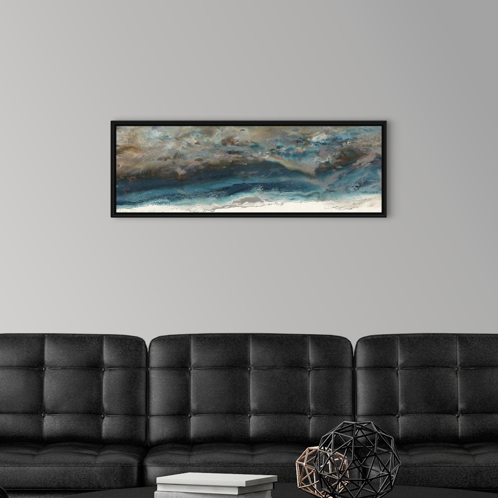 A modern room featuring Abstract painting in deep blue and light beige resembling an aerial view of the ocean and shore.