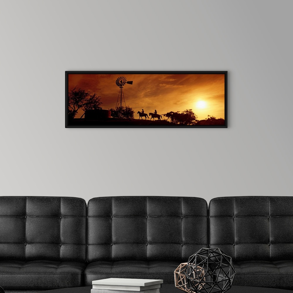 A modern room featuring Landscape, panoramic artwork of a hill with a windmill perched at the top on a farm at twilight.