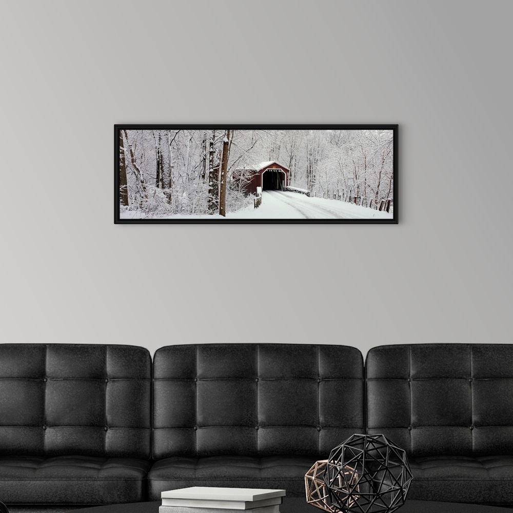 A modern room featuring Panoramic photograph of a snow covered bridge in Pennsylvania that is surrounded by a forest.