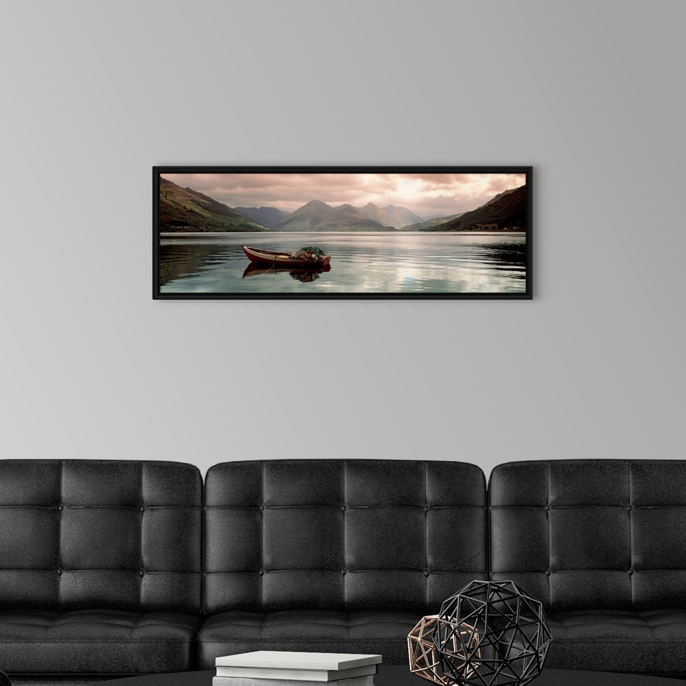 A modern room featuring Panoramic photograph shows a small fishing vessel sitting anchored within a calm body of water no...