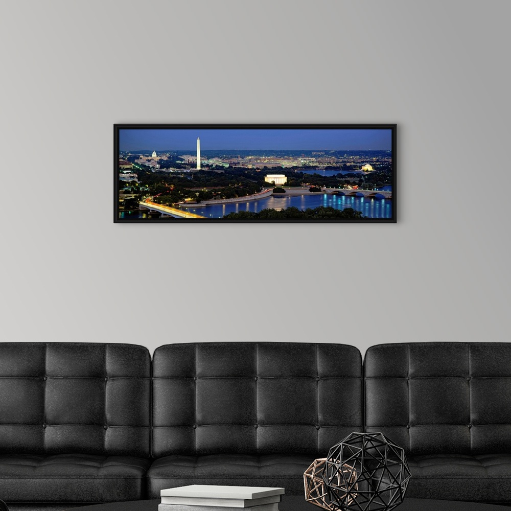 A modern room featuring Panoramic photograph of the nation's capital at night with bright lights reflected in the water. ...