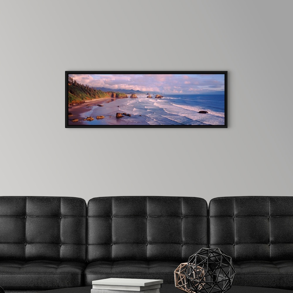 A modern room featuring Panoramic photograph of waves slowly crashing against the rocks and sand of Cannon Beach in Orego...