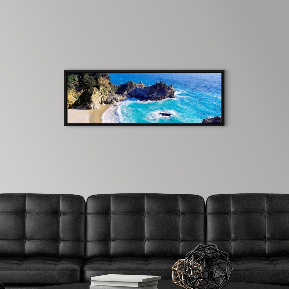 A modern room featuring Panoramic photograph of waves from the Pacific ocean crashing into the jagged rocks within McWay ...