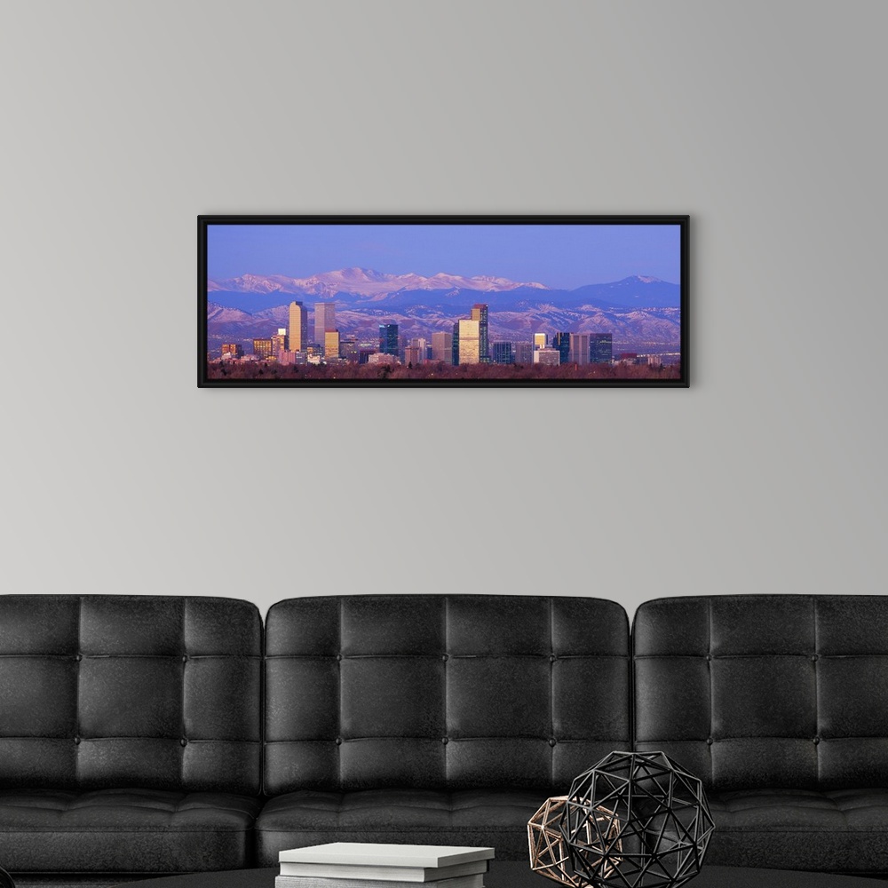 A modern room featuring Panoramic view of the Rocky Mountains and downtown skyline of the Mile High City, Colorado in the...