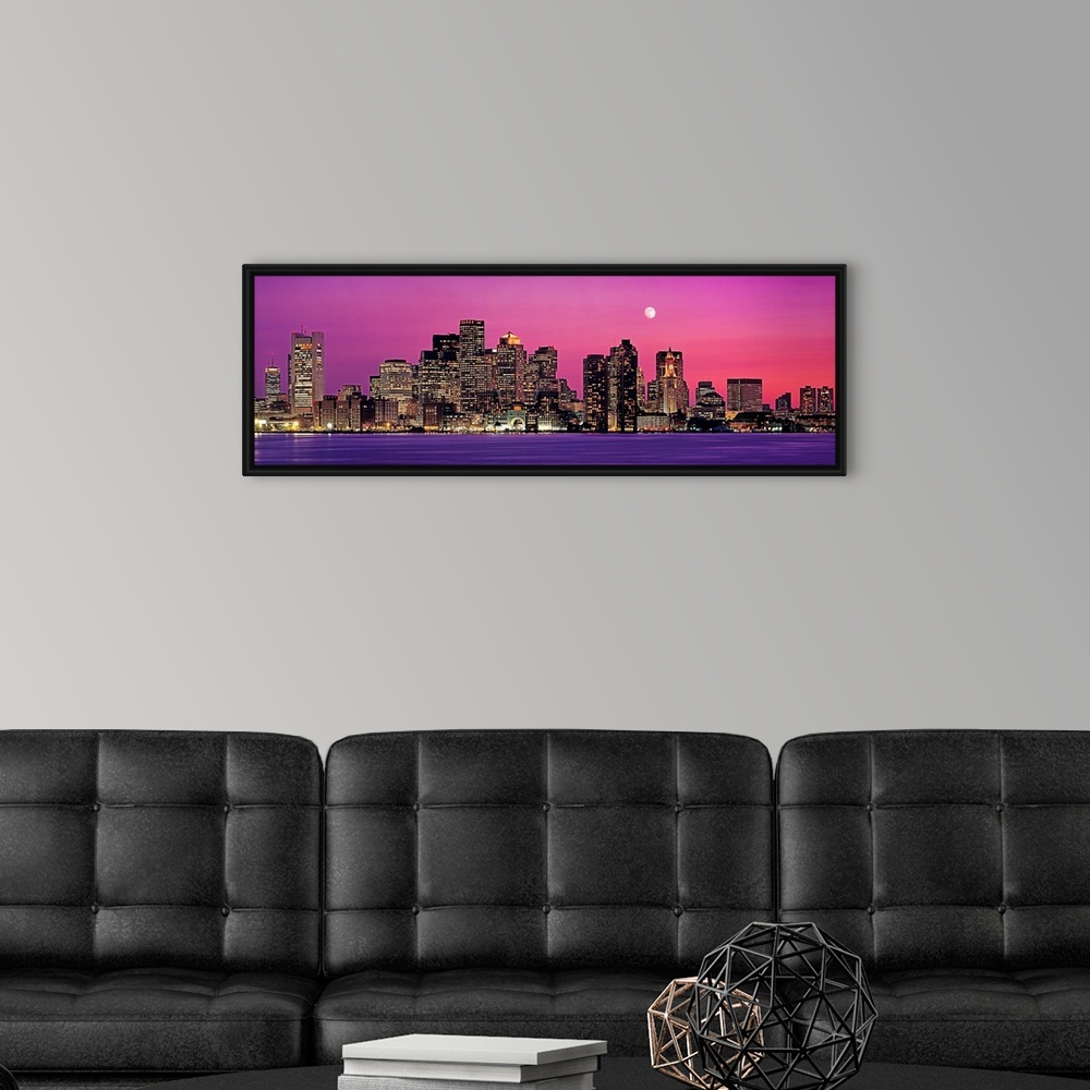 A modern room featuring Panoramic photograph of a skyline in Boston, Massachusetts at night by the shore.  The moon in th...