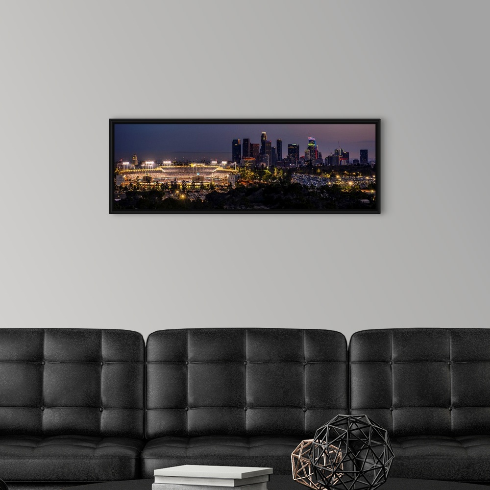 A modern room featuring Panoramic photograph of Dodger Stadium lit up on a game night with the Los Angeles skyline on the...