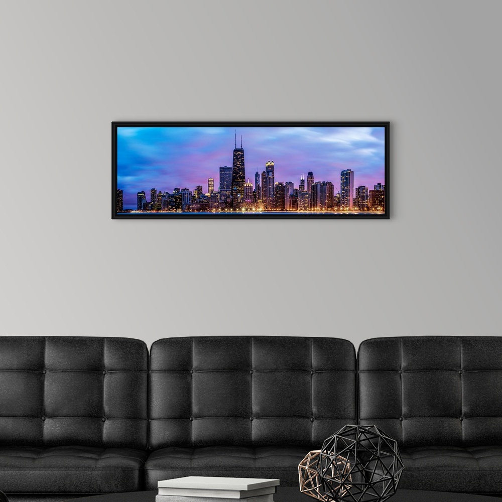 A modern room featuring Photo of Chicago skyline at night under cotton candy colored clouds.