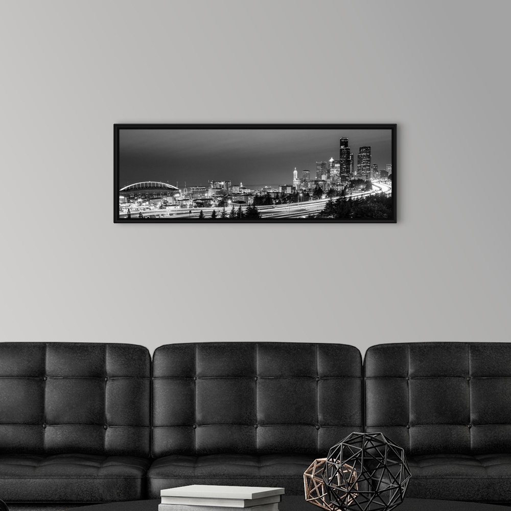 A modern room featuring Panoramic photograph of the Seattle skyline with the stadium on the left and light trails from tr...