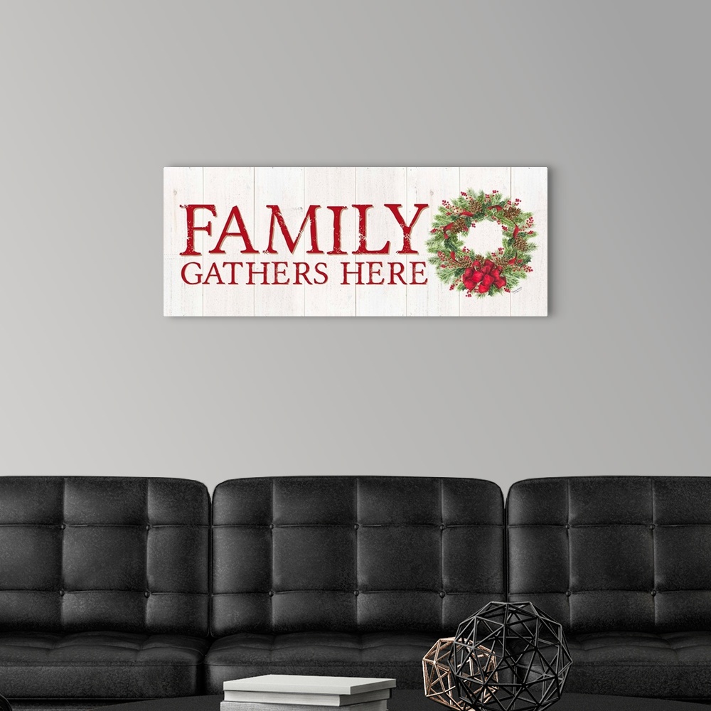 A modern room featuring "Family Gathers Here" in red with a holiday wreath on a white wood panel backdrop.