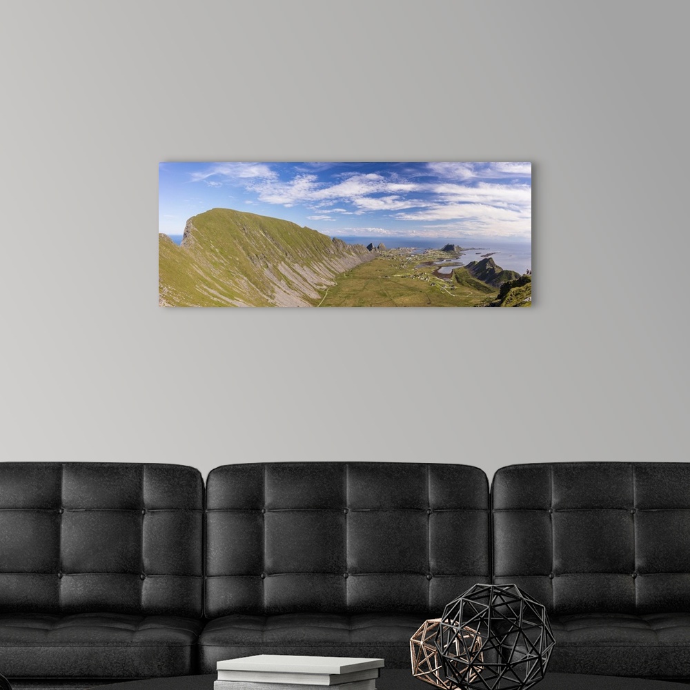 A modern room featuring Mountain ridge frames the village of Sorland surrounded by sea, Vaeroy Island, Nordland county, L...
