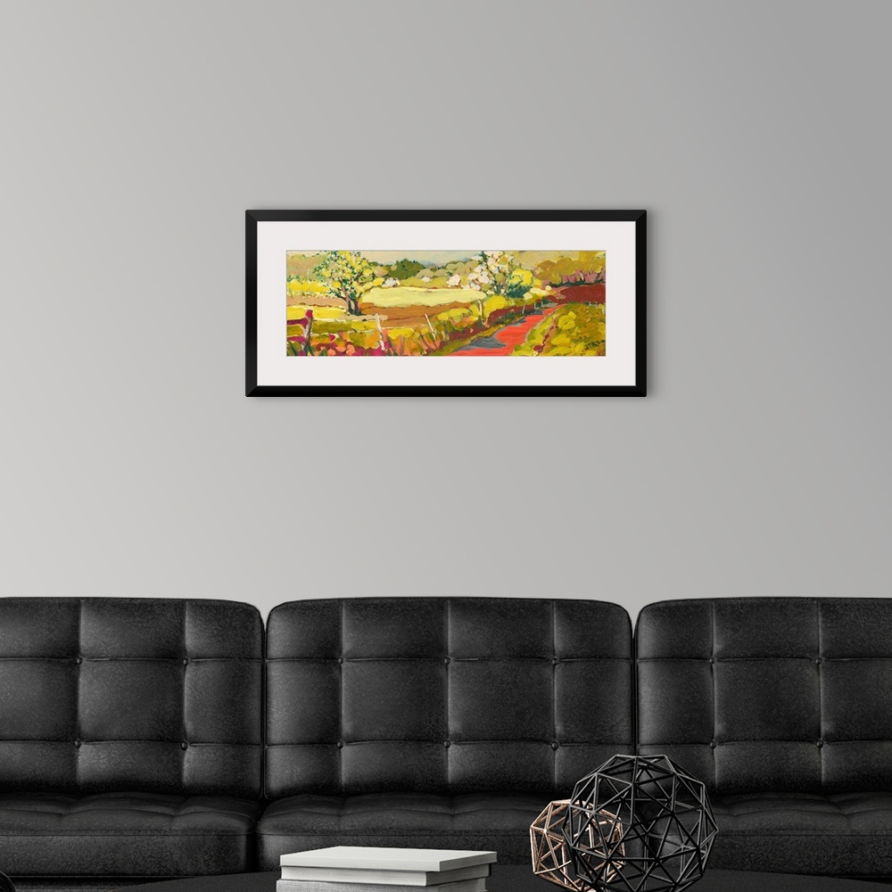 A modern room featuring A panoramic piece of artwork that displays a road in the countryside.  The fence and large tree i...