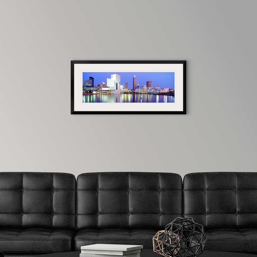 A modern room featuring Large, panoramic photograph of the Cleveland skyline at dusk, reflecting in the waters of Lake Erie.