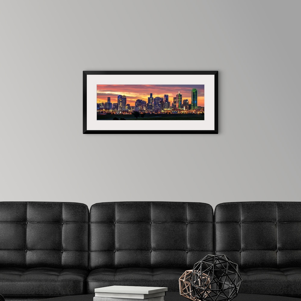 A modern room featuring A horizontal image of the Dallas, Texas city skyline with a brilliant sunset.