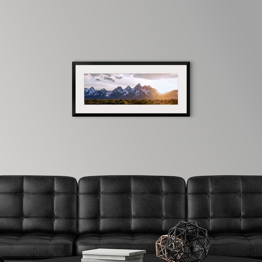A modern room featuring Panoramic view of the sun rising over Teton mountains in Wyoming.