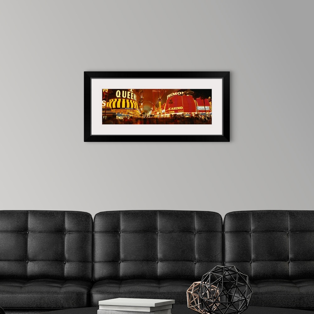 A modern room featuring Wide angle photograph on a giant canvas of the casinos with bright lights at night, along Fremont...
