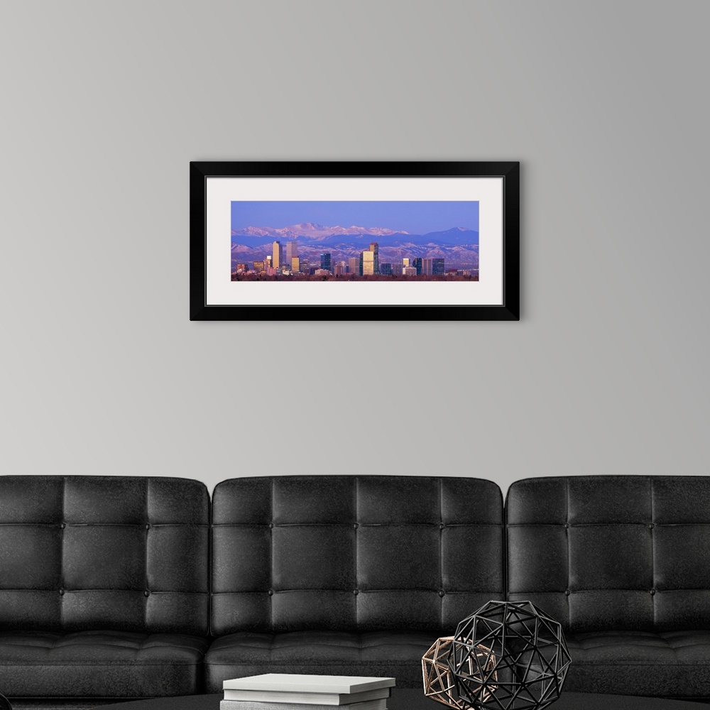 A modern room featuring Panoramic view of the Rocky Mountains and downtown skyline of the Mile High City, Colorado in the...