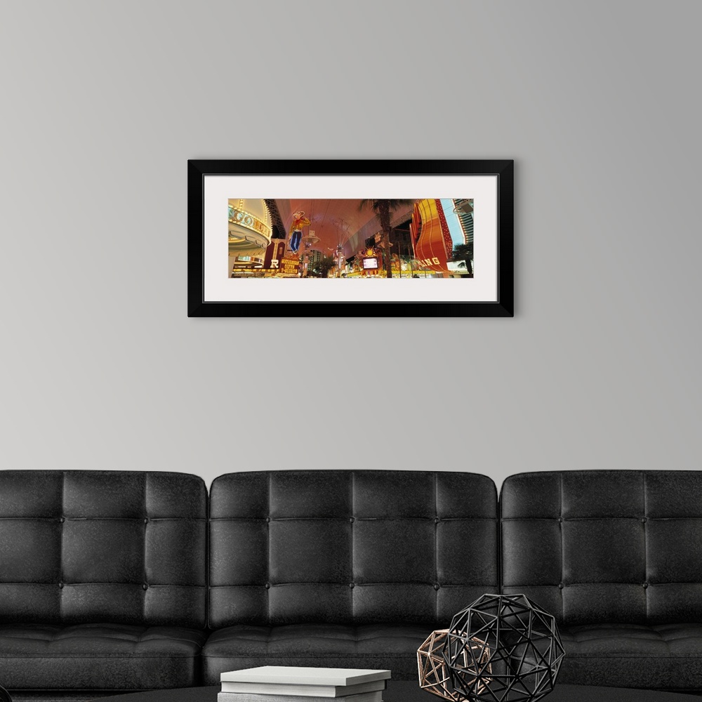 A modern room featuring Horizontal photo of the Las Vegas Strip lit up from street view.