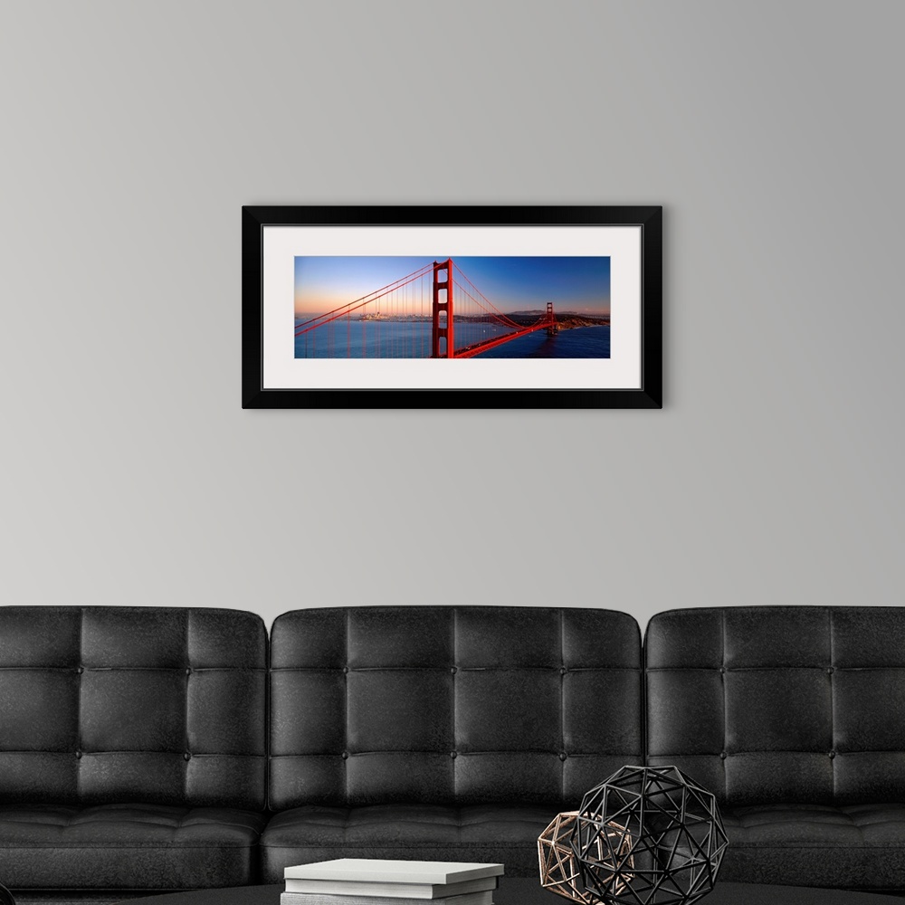 A modern room featuring Big landscape photograph of the Golden Gate Bridge extending over the blue waters of the San Fran...