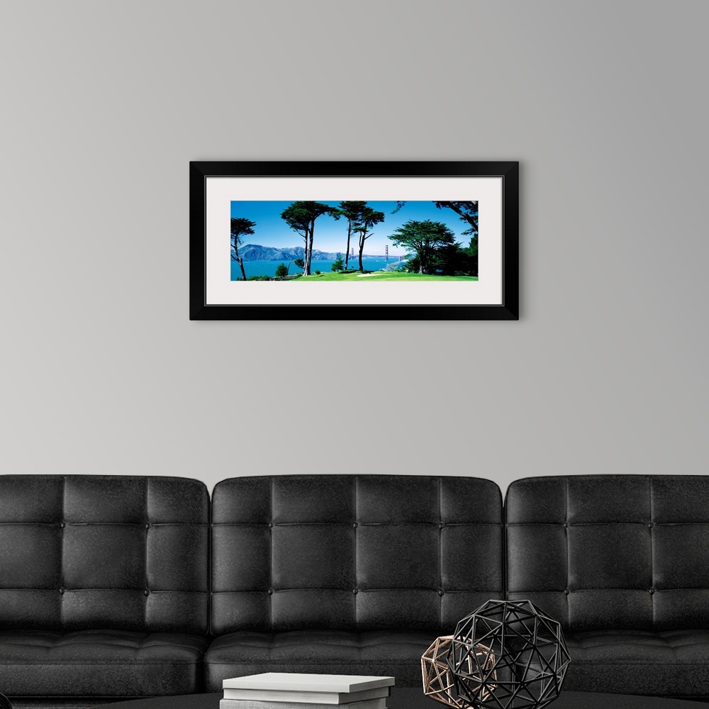 A modern room featuring Big panoramic photograph of a seaside golf course in San Francisco, California (CA) with mountain...