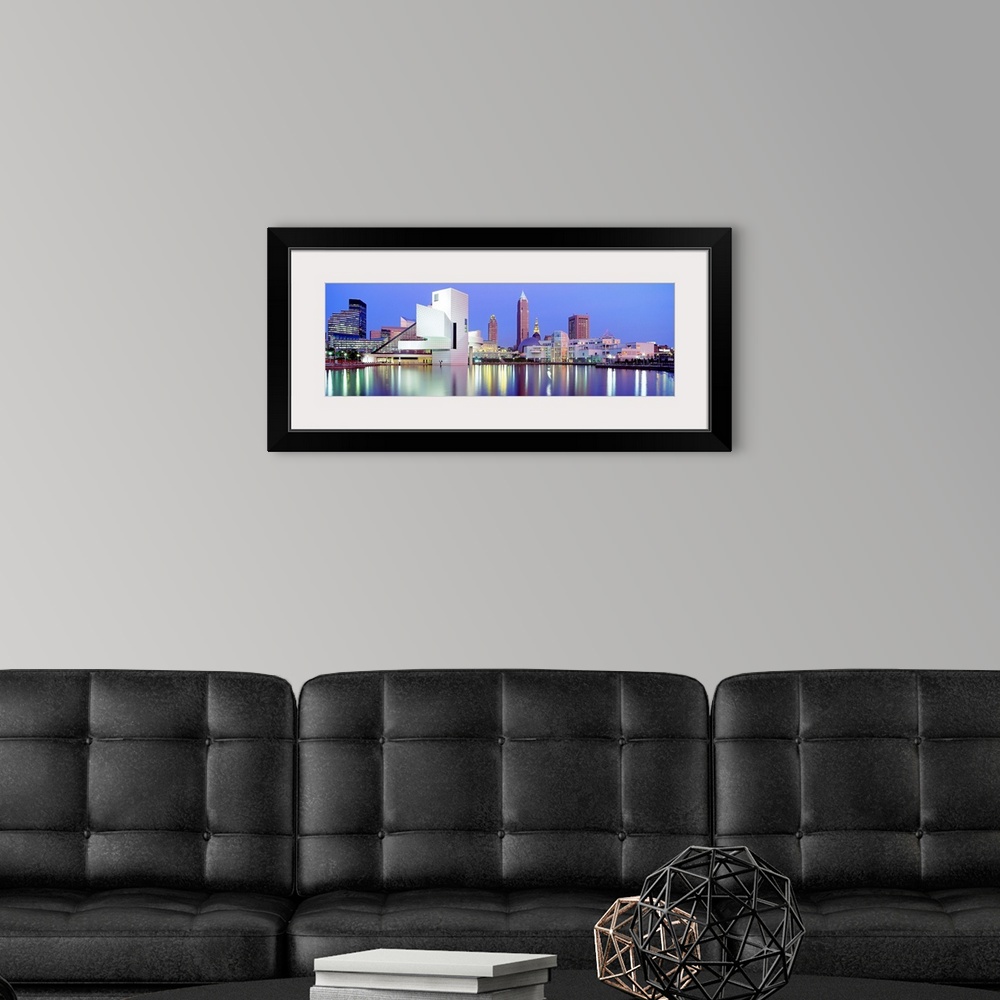 A modern room featuring Large, panoramic photograph of the Cleveland skyline at dusk, reflecting in the waters of Lake Erie.