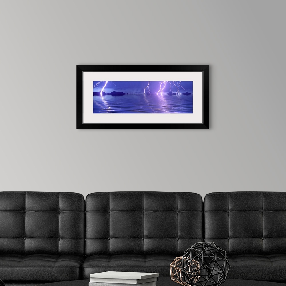 A modern room featuring Panoramic photograph of thunder bolts over the ocean at night.  There are mountains scattered in ...